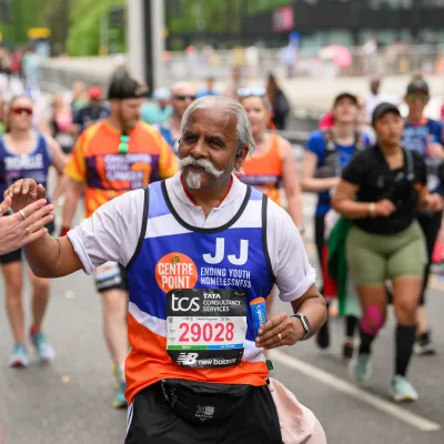 Man running high fiving people cheering