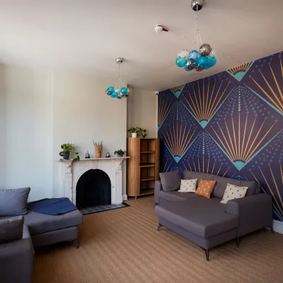 Centrepoint accommodation recently refurbished with new sofas, lighting and stylish wallpaper through Nationwide More Than a Roof