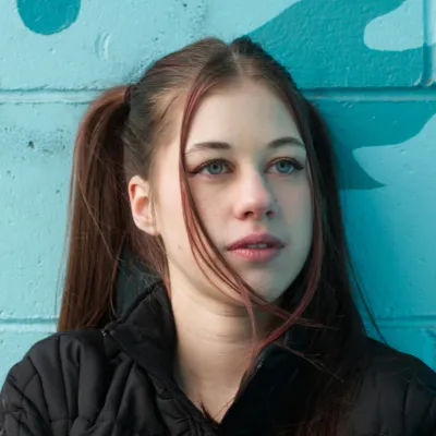 Young woman in front of blue wall