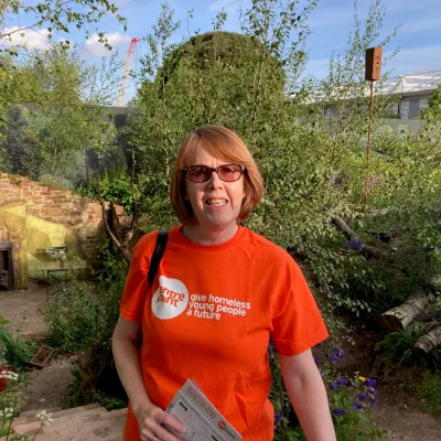 Woman smiling at camera in a garden