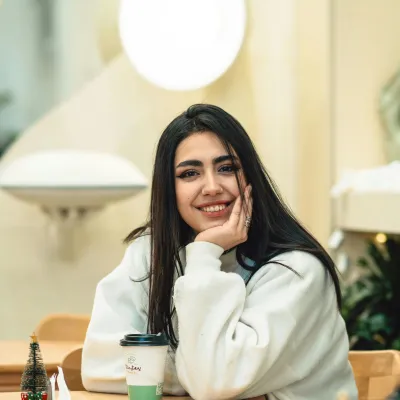 Young woman smiling having a coffee